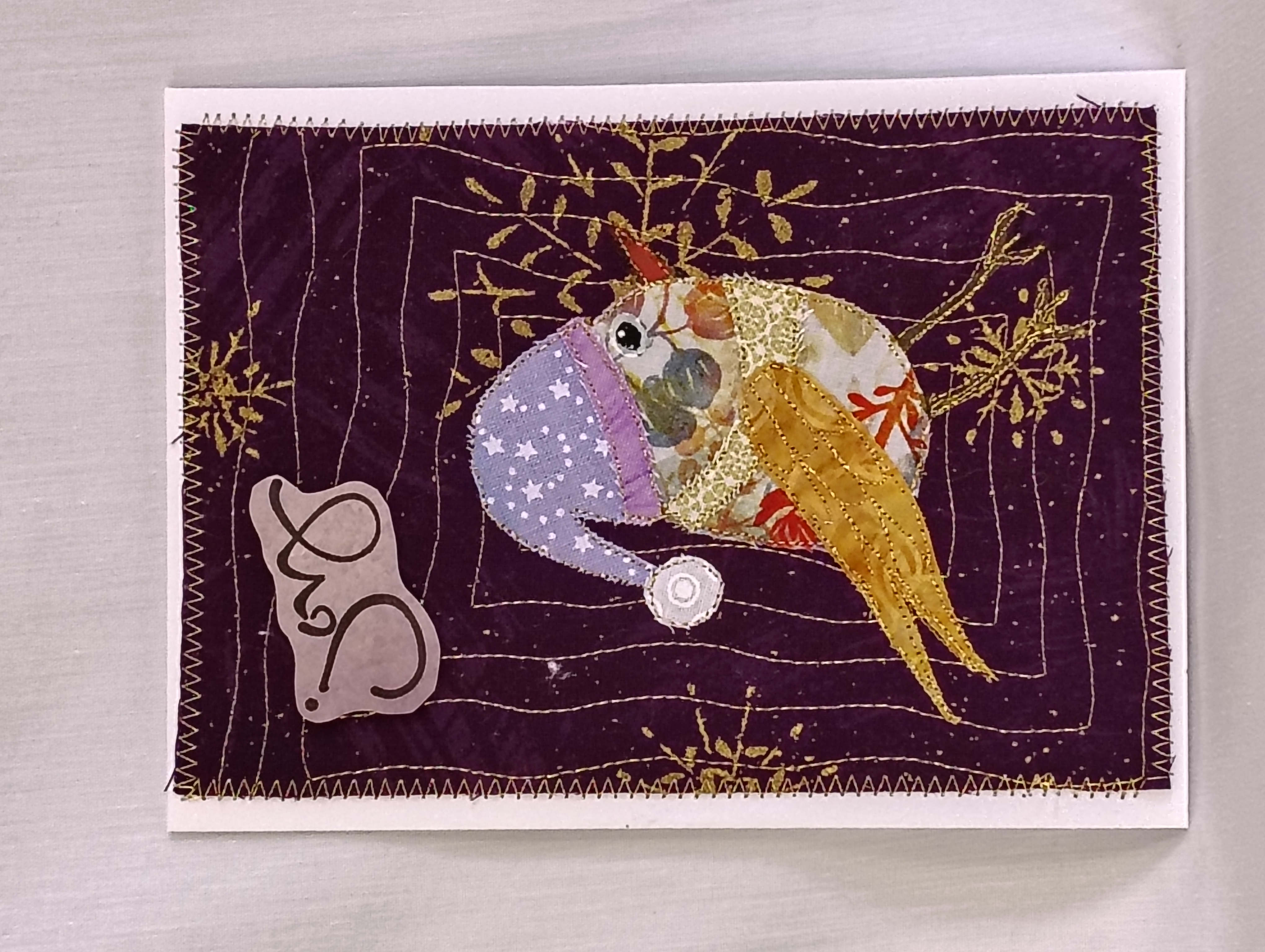 Handmade holiday greeting card with joyful Santa birdie
