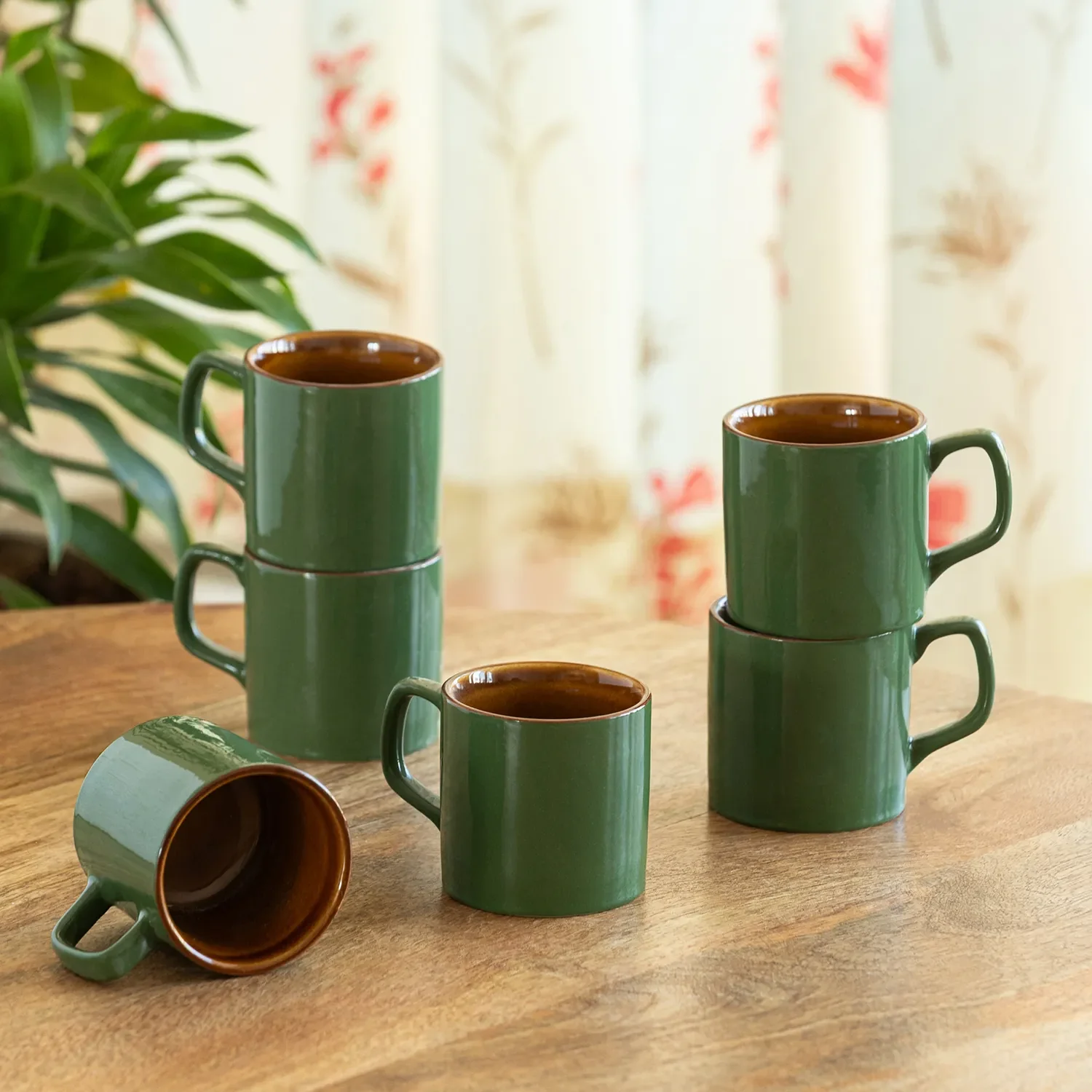 Set of green ceramic mugs