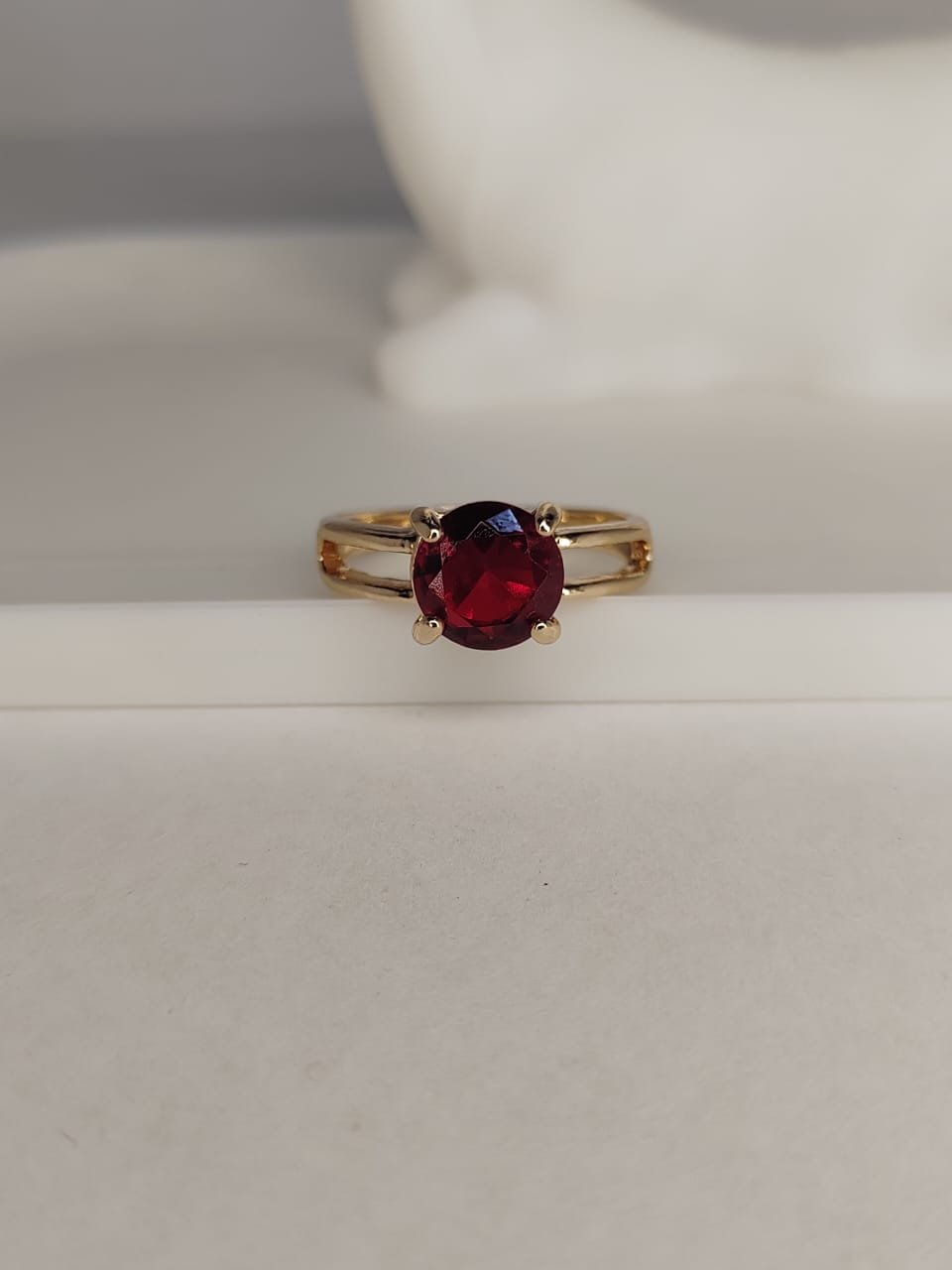 Gold ring with red gemstone