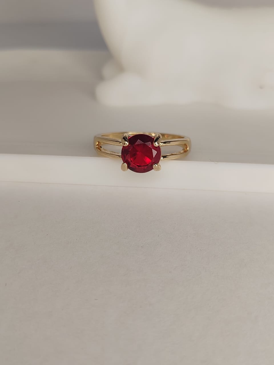 Gold ring with red gemstone