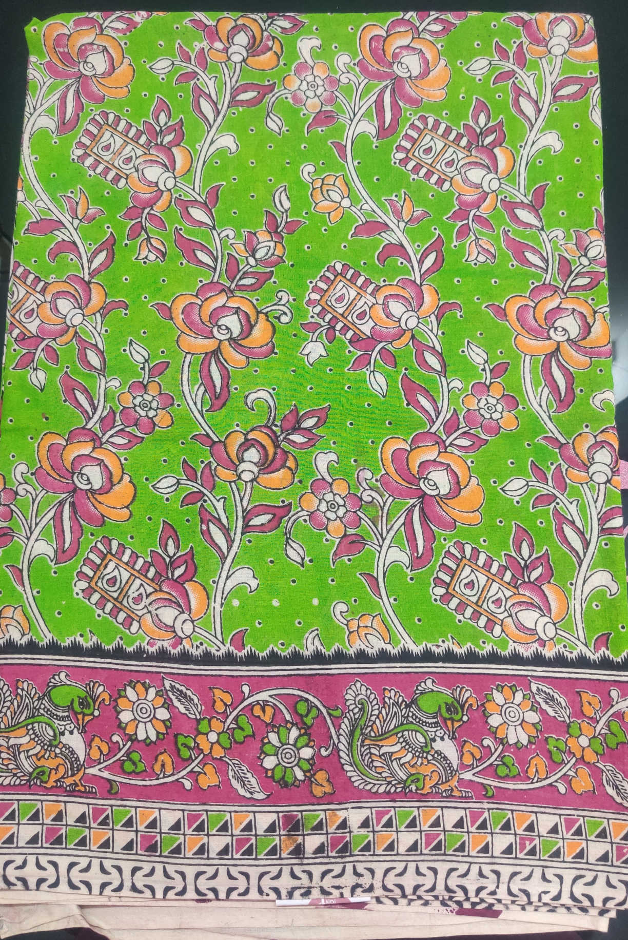 Kalamkari Cotton Saree – Vibrant Green Base with Pink–Orange Floral Body & Traditional Kalamkari Peacock Border