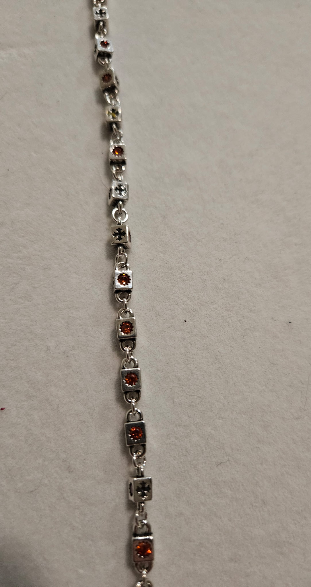 Silver bracelet with red gemstones