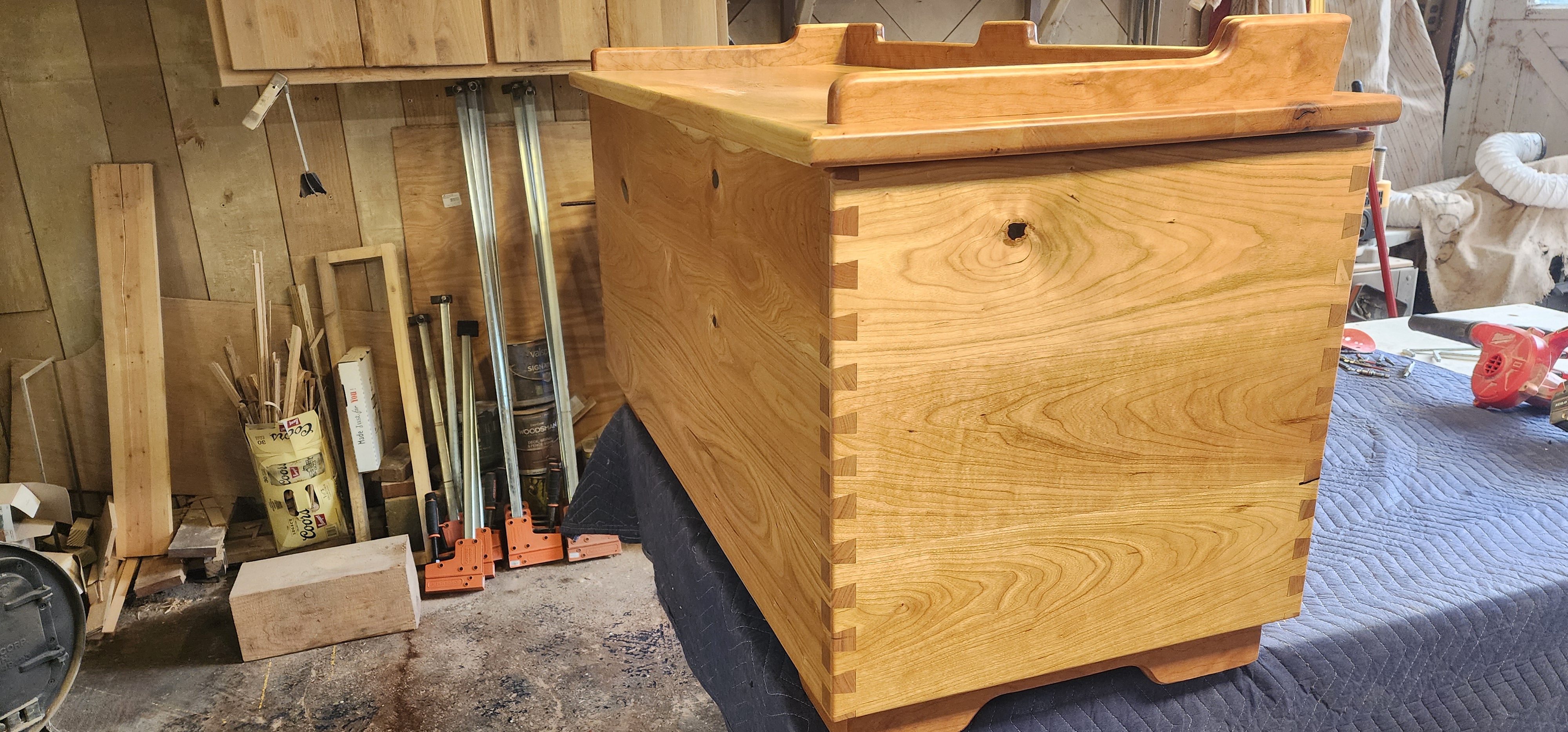 Engraved cherry hope chest with cedar lined bottom. dovetail corners and sitting rail on lid.
