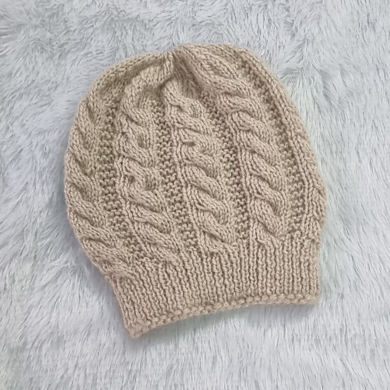 Hand-knitted beige wool beanie