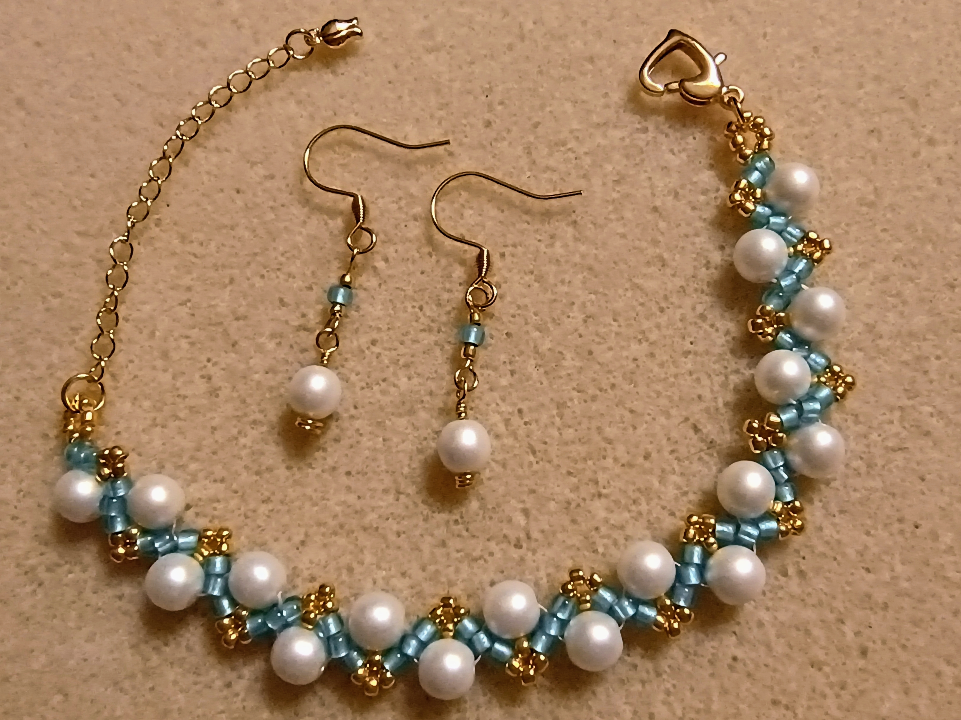 Elegant Glass Pearl & Bead Zigzag Bracelet in white, blue and gold with heart clasp