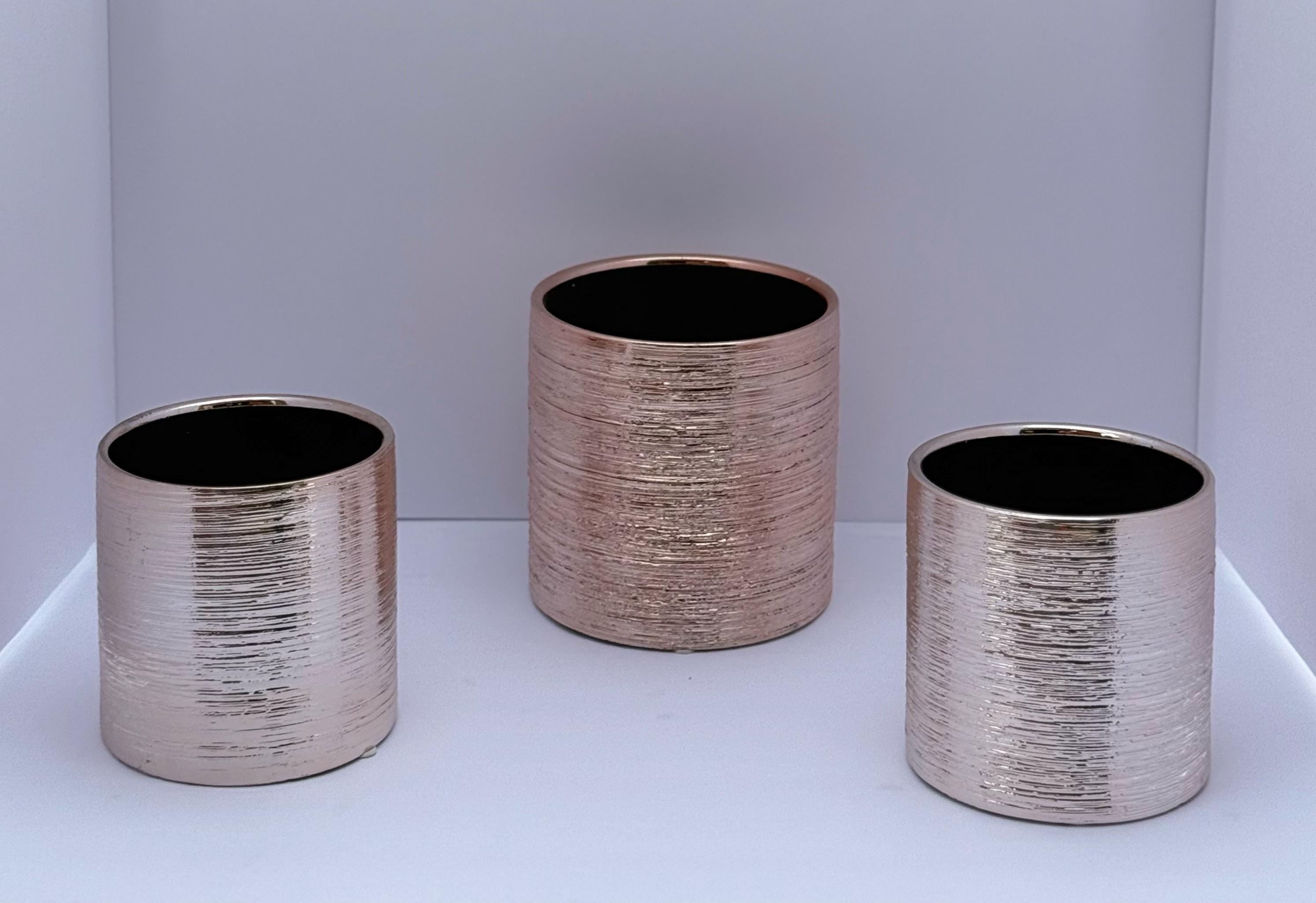 Set of metallic cylindrical vases