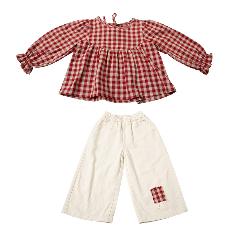 Red plaid top and cream pants with patch detail