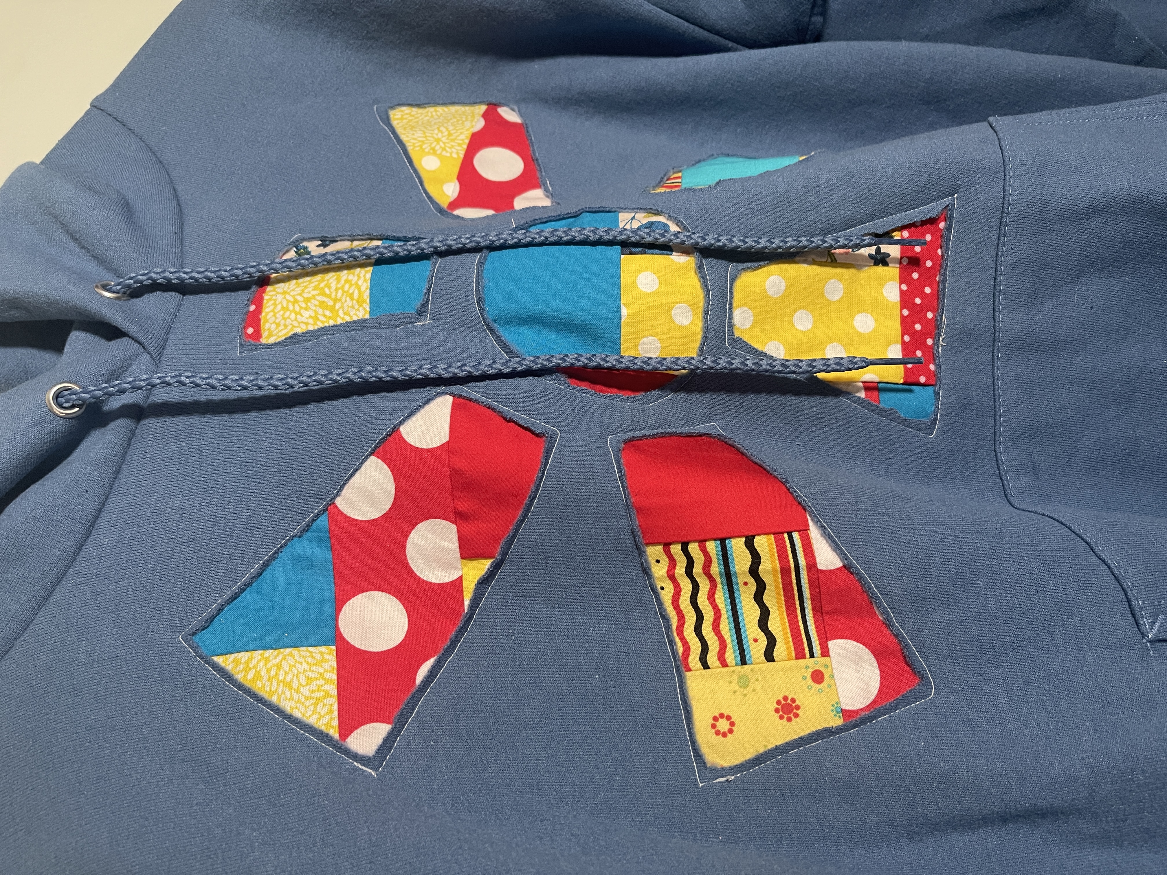 Blue, Red and Yellow Reverse Applique Wonky Flower Upcycled Hoodie