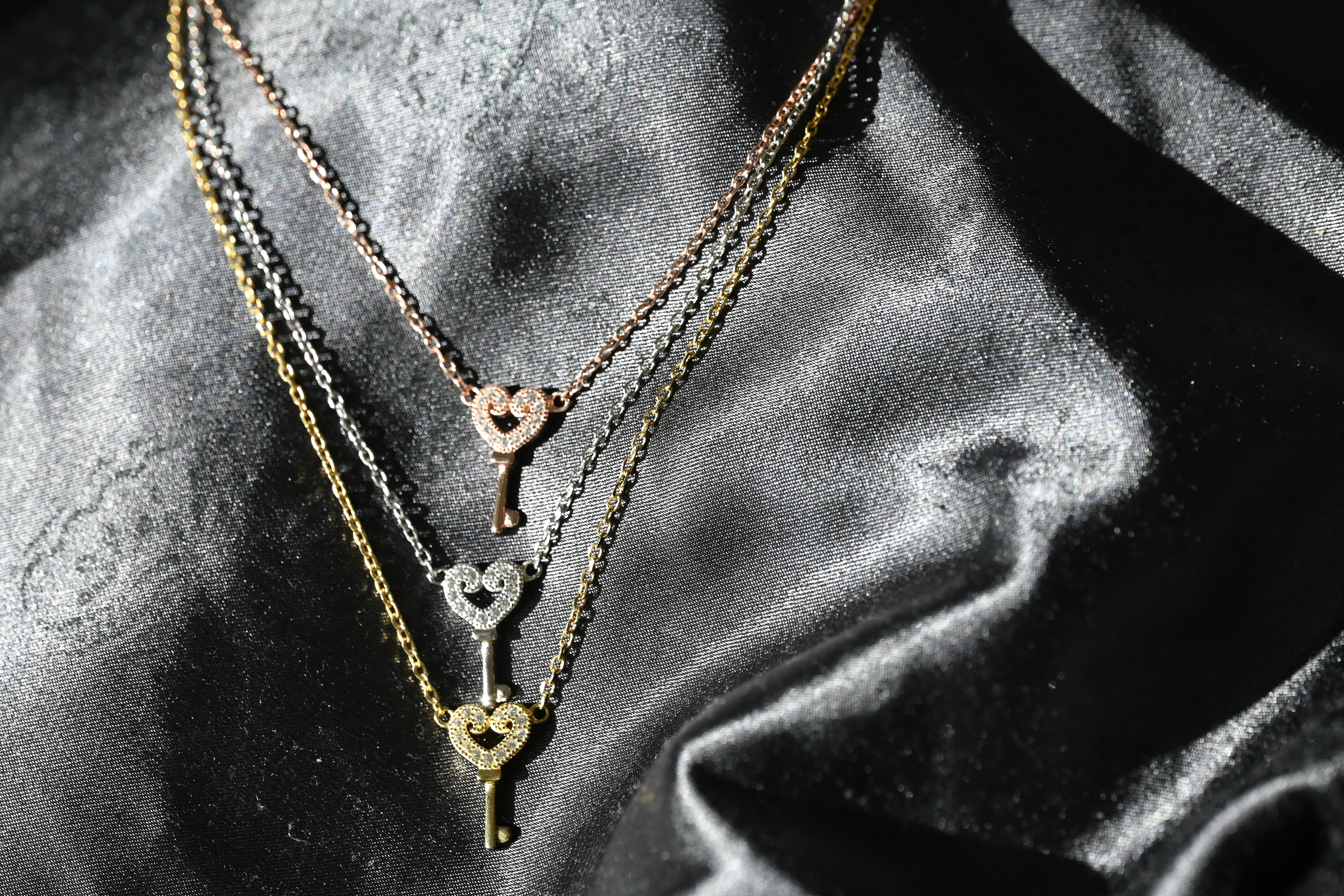 Silver necklace with colored harted in key lines