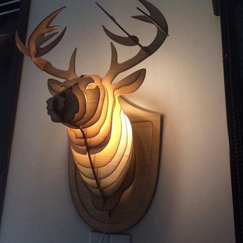 Decorative wooden wall lamp in the shape of a deer head
