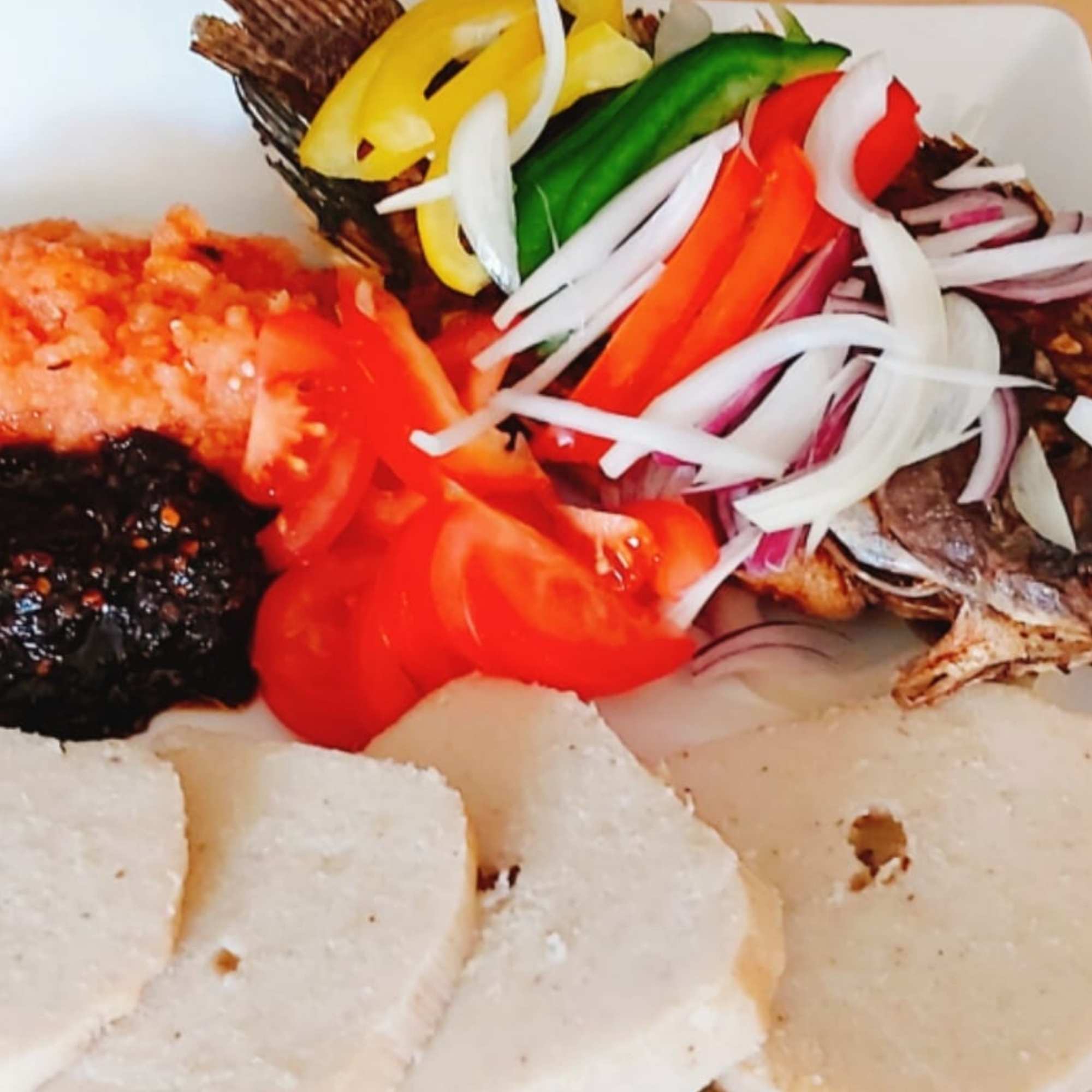 Kenkey with fried fish and hot pepper