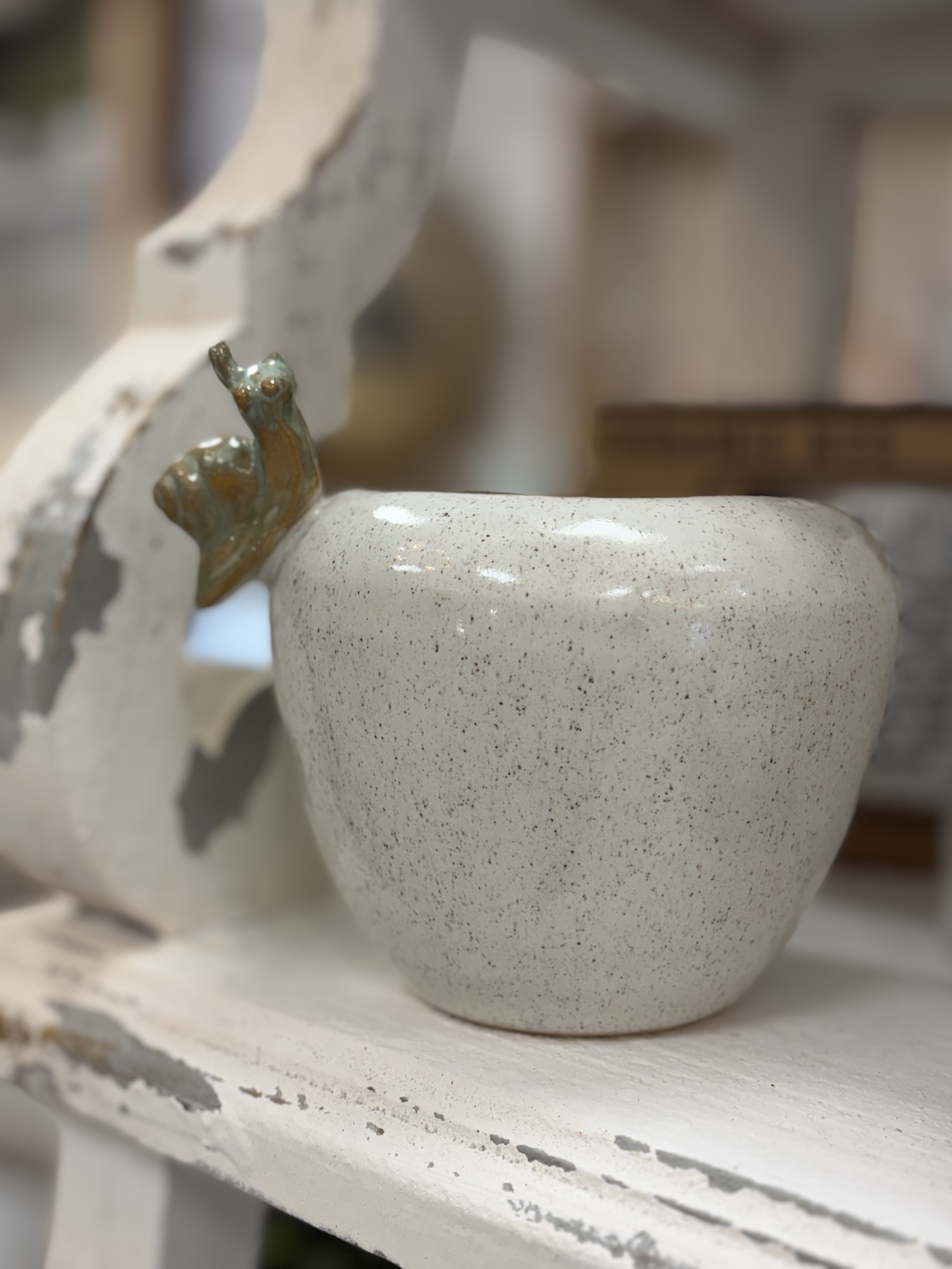 Ceramic pot with snail on rim