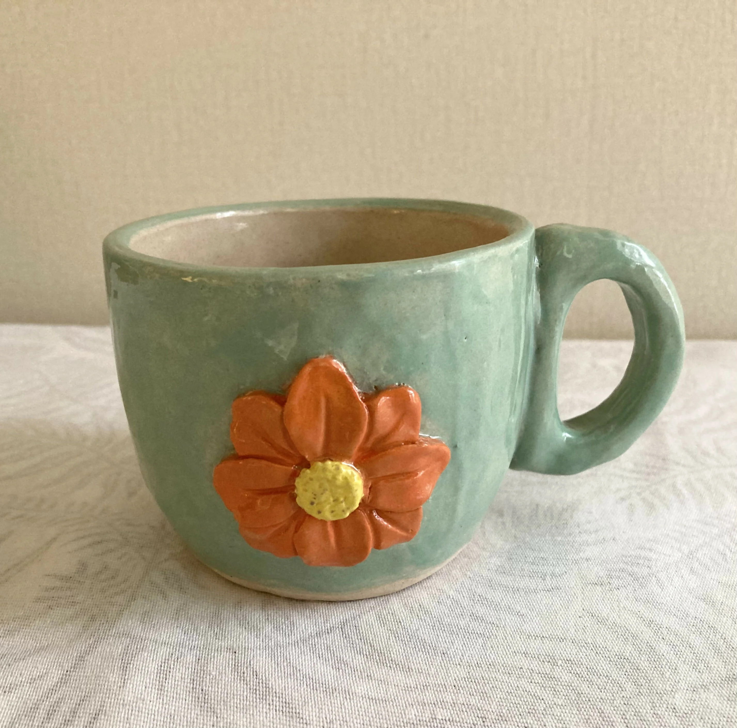 Coil and pinch handmade marigold flower tea cup