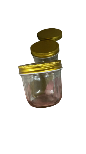 Frasco de vidrio con tapa dorada