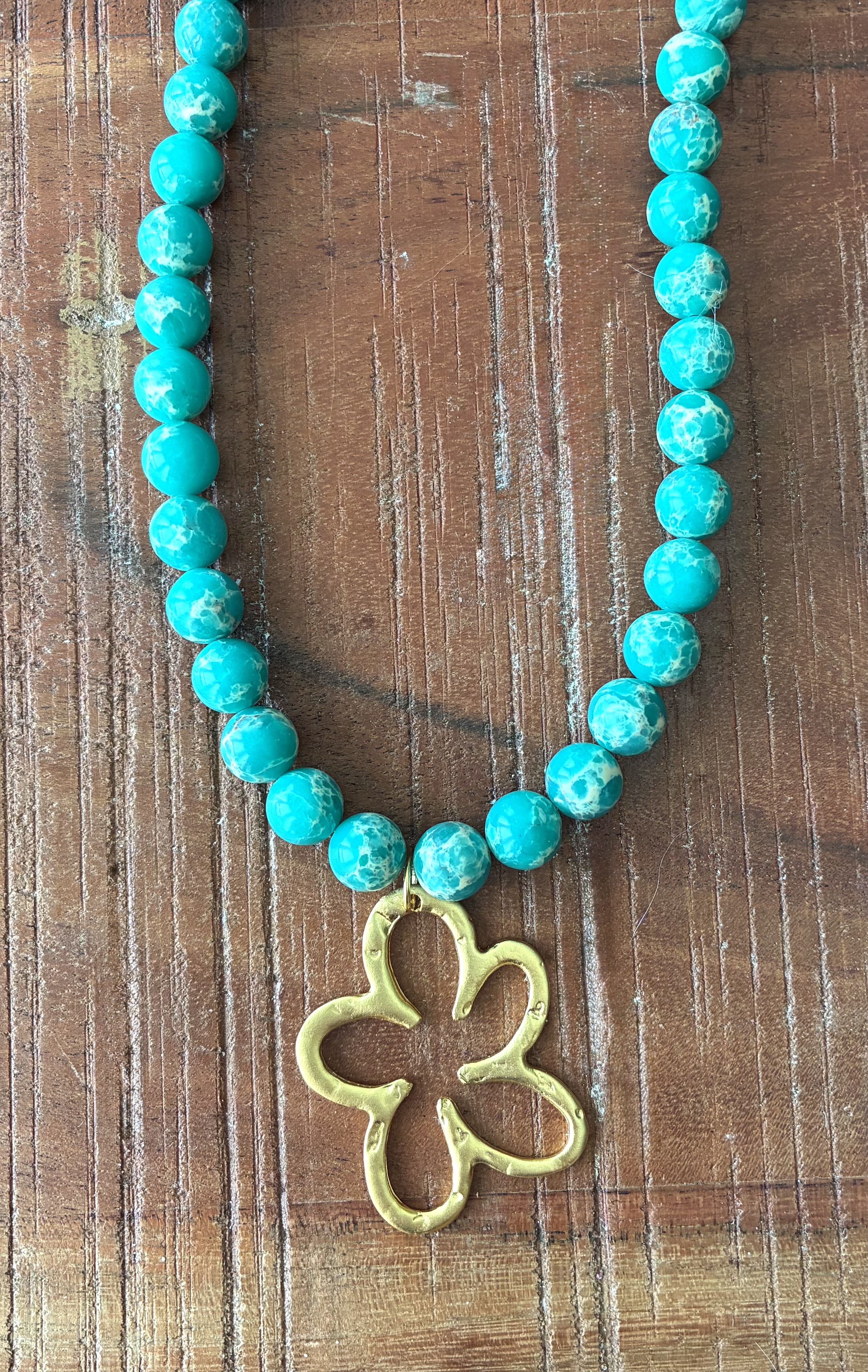 Bold Turquoise-Colored Necklace with Hammered Gold Flower