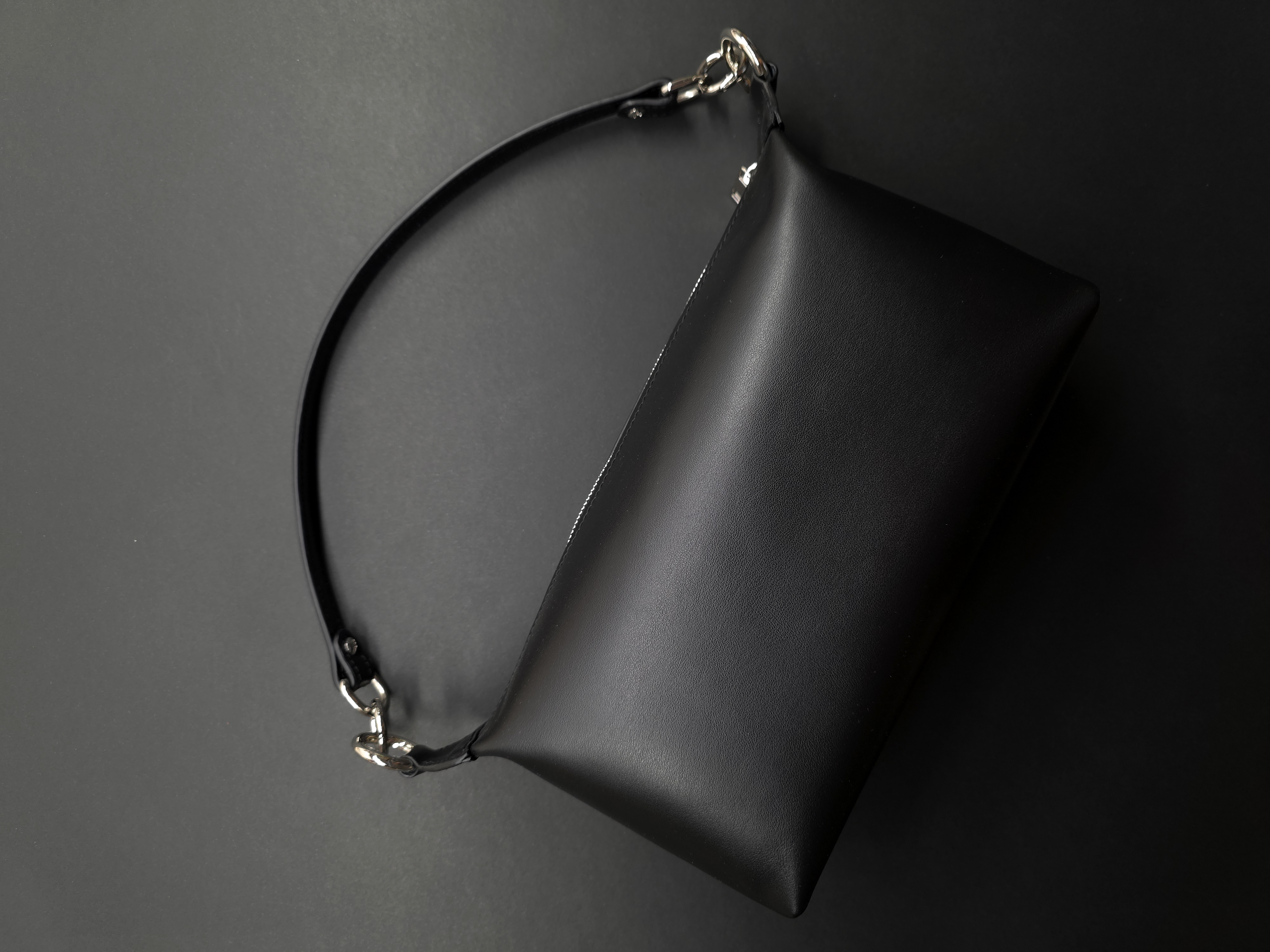 Compact leather handbag with removable top handle and shoulder strap