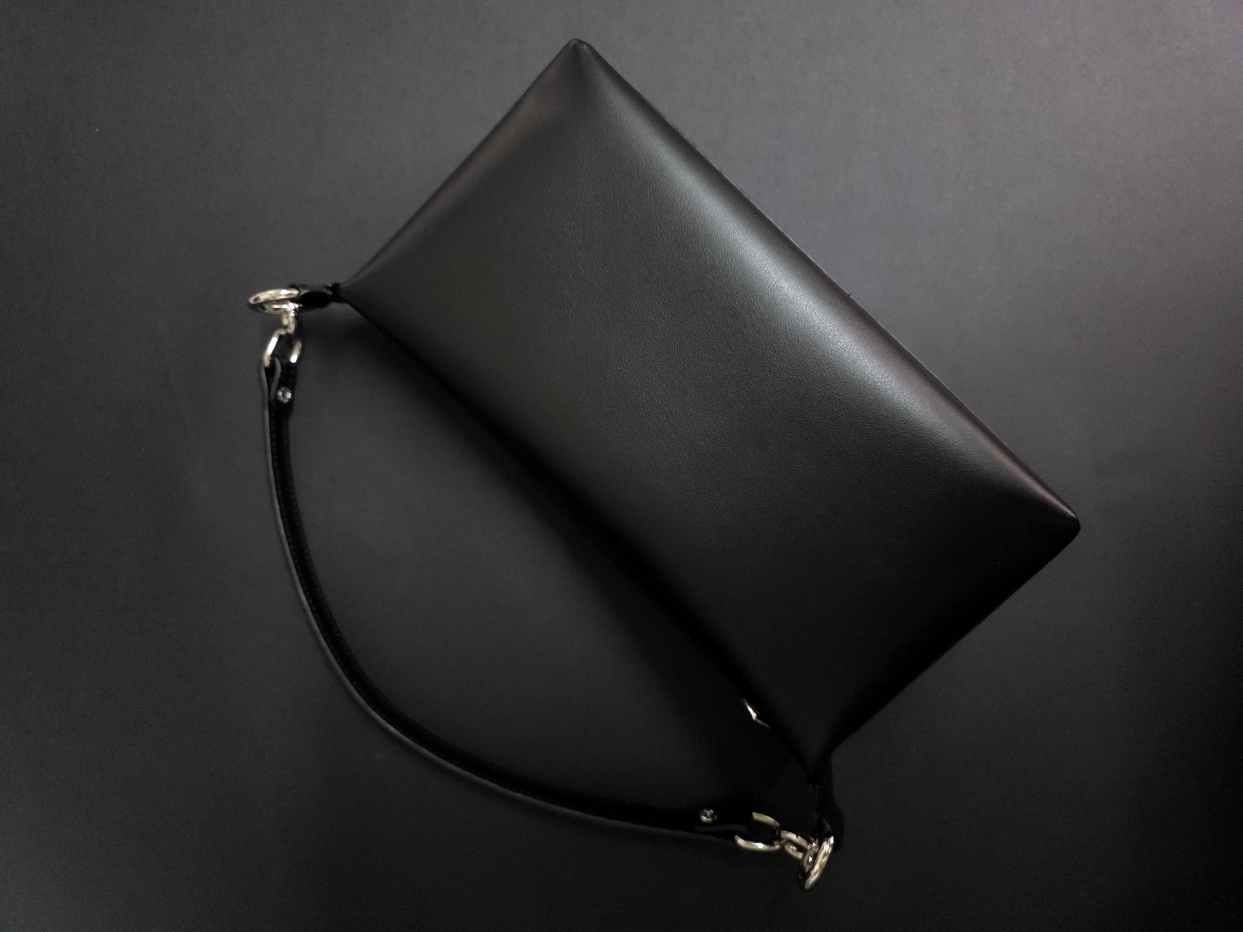 Compact leather handbag with removable top handle and shoulder strap