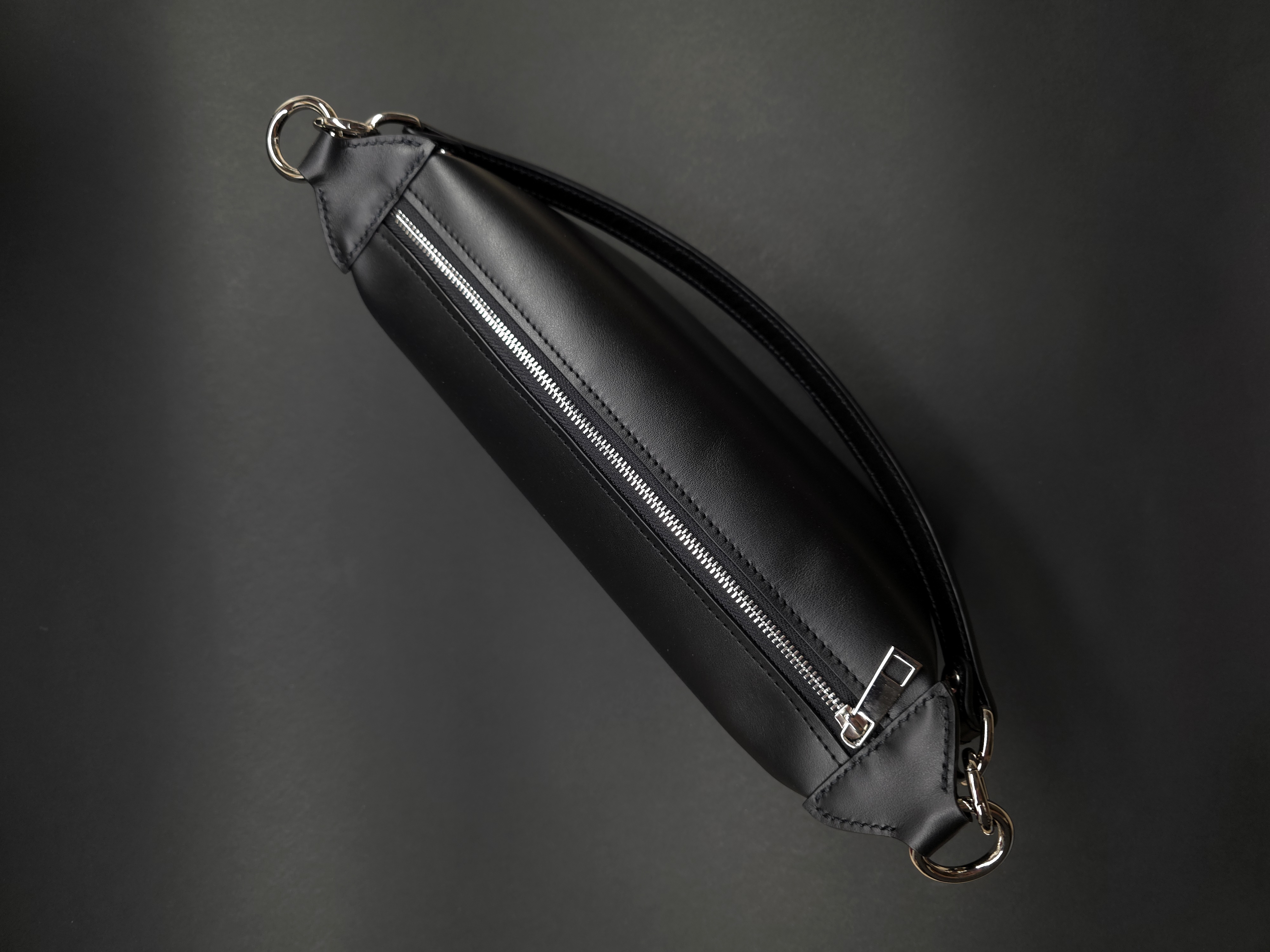 Compact leather handbag with removable top handle and shoulder strap