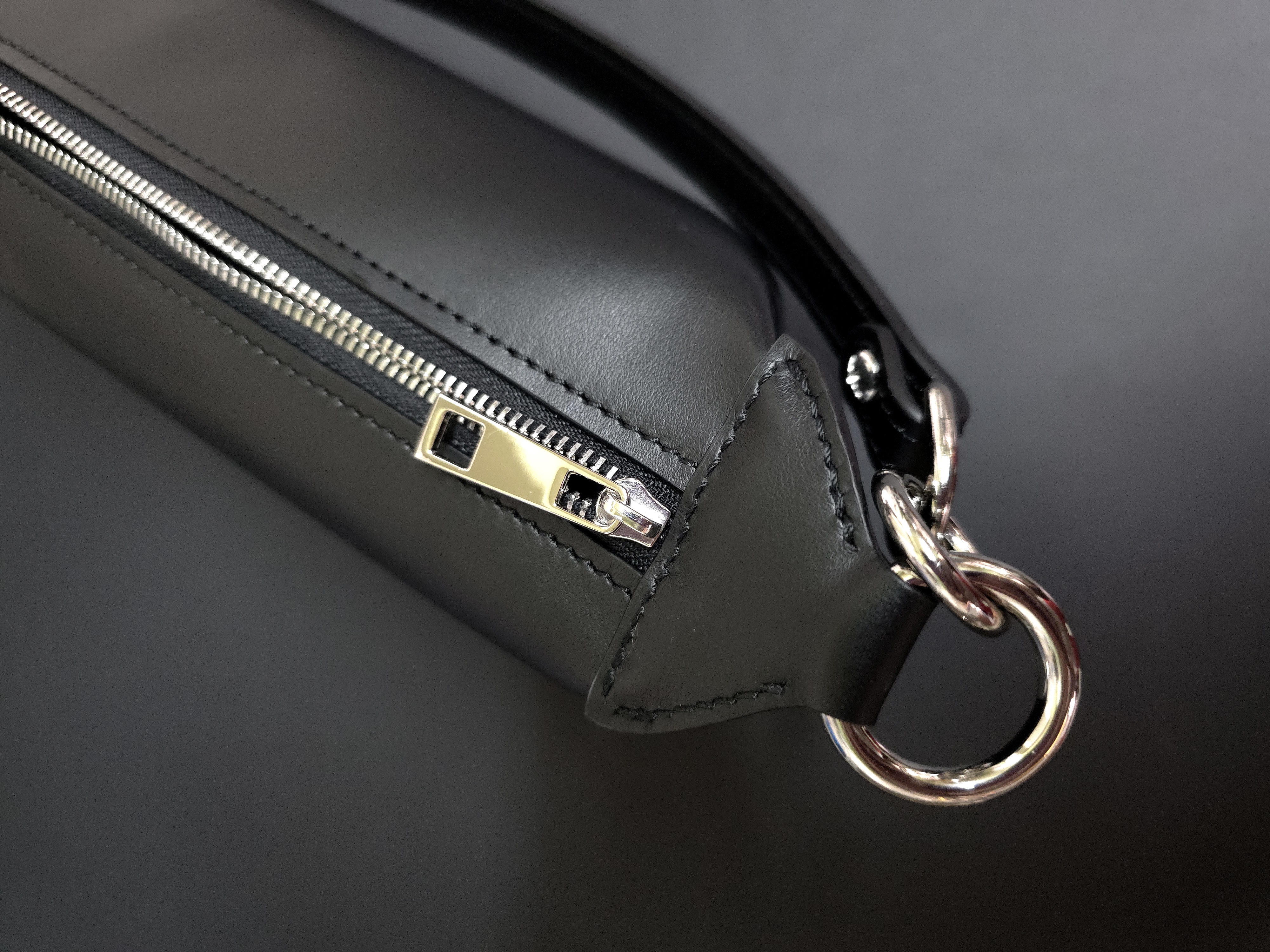 Compact leather handbag with removable top handle and shoulder strap