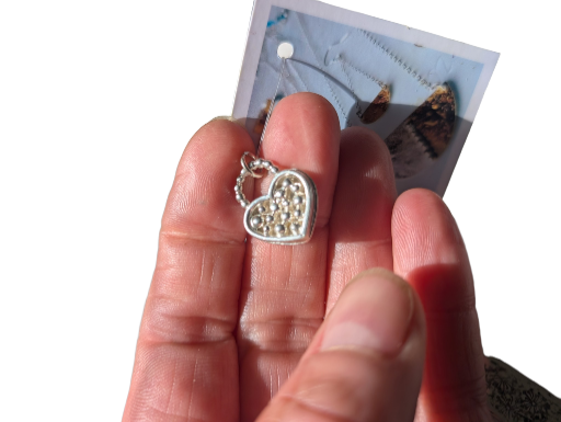 Sterling silver pendant, heart shaped with detail.