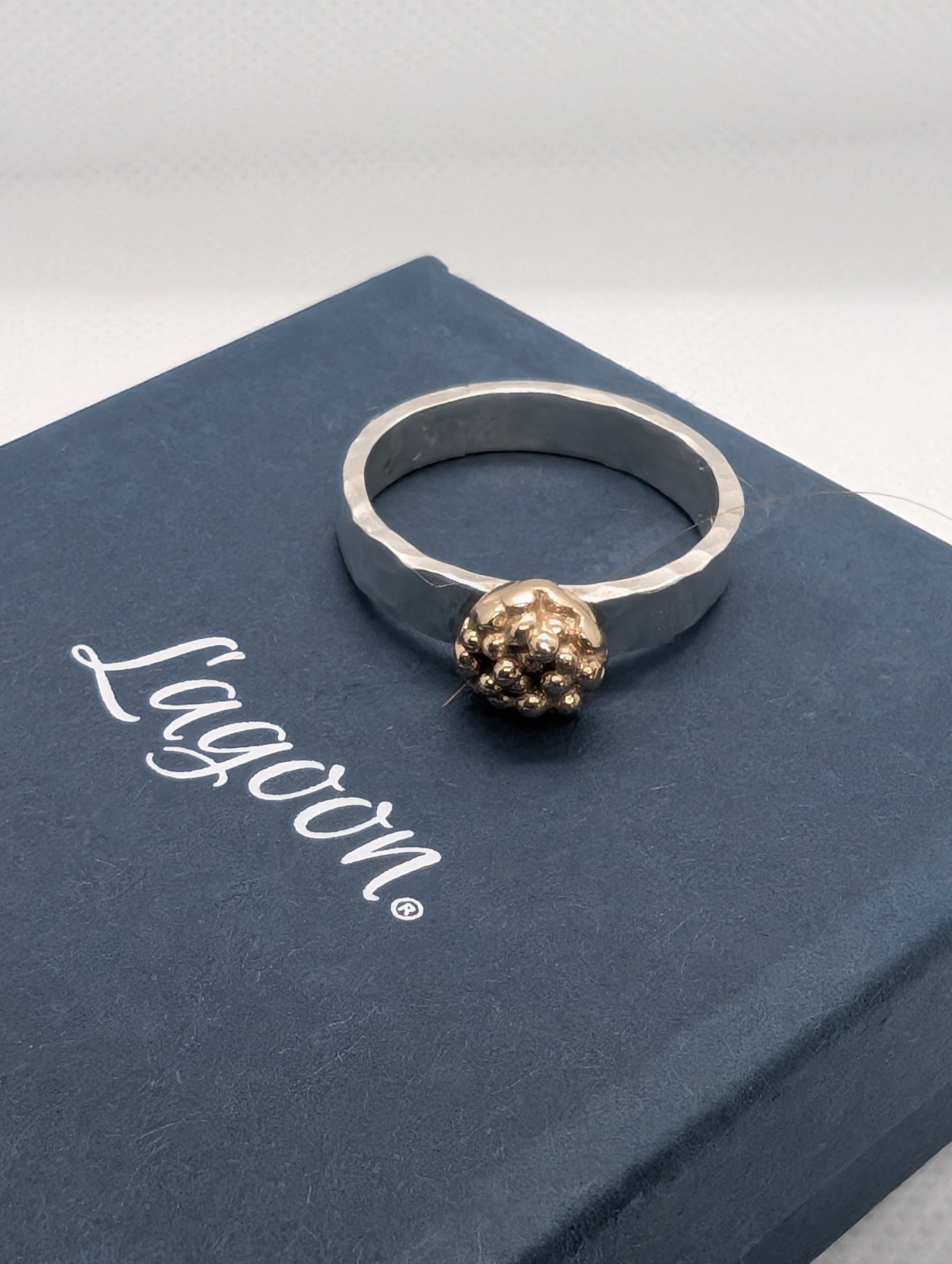Sterling silver ring with 9ct gold accent. Hammered finish using recycled silver and gold, Size M