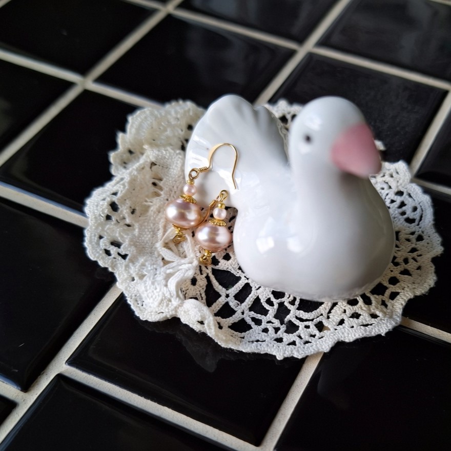 Pink glass pearl earrings with reflective card on engagement