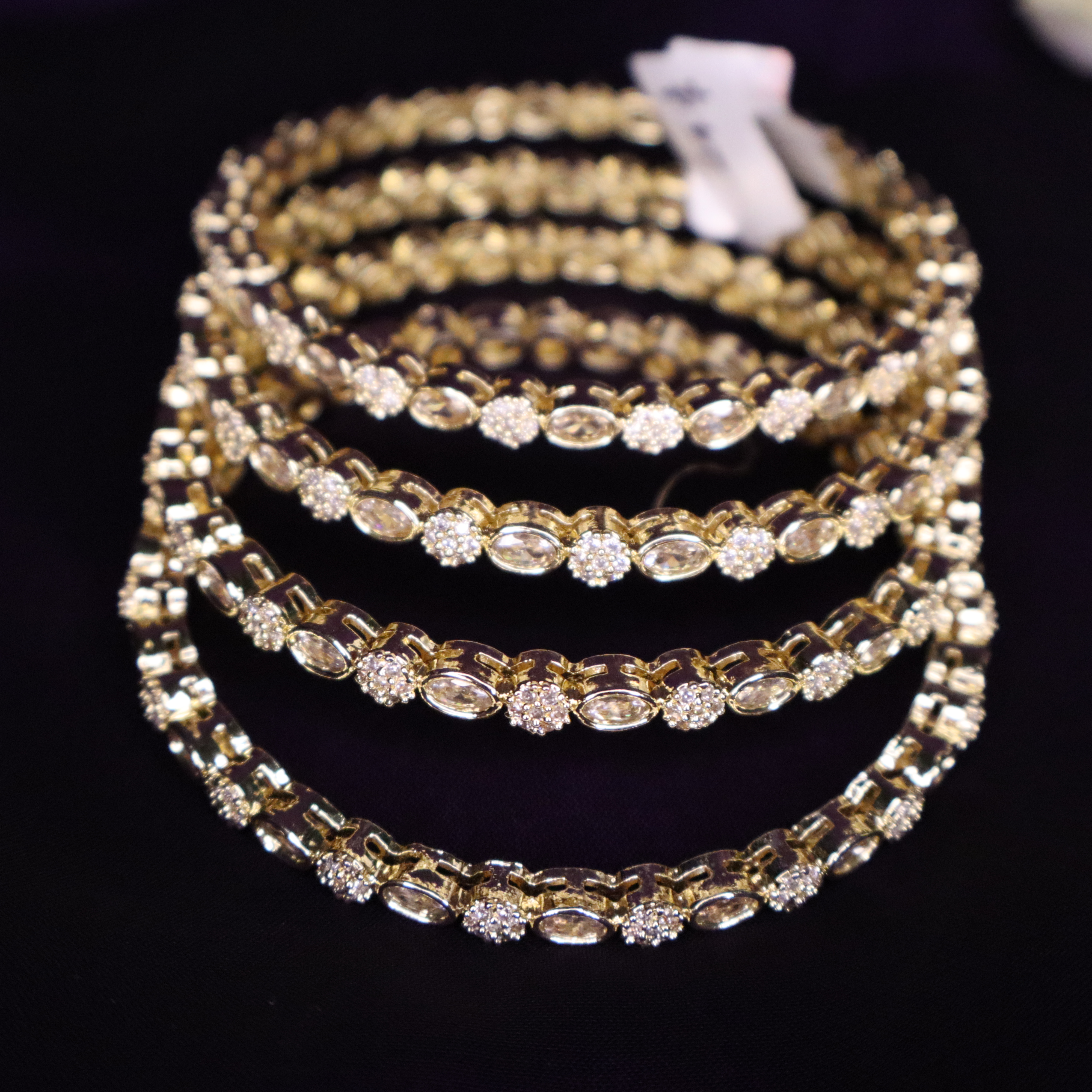 Stone embedded gold tone bangles