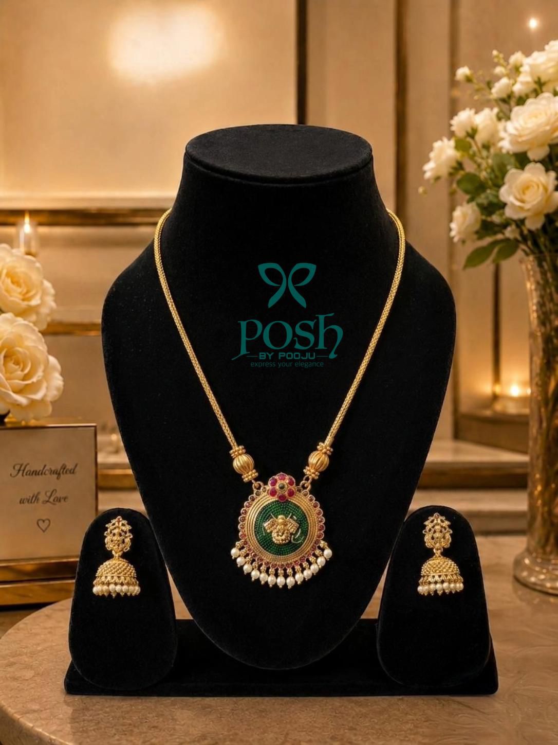 handcrafted pendant set with matching jhumkas in green & pink combination in gold finish.