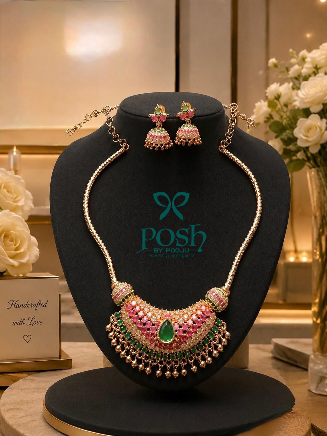 Statement neckpiece with matching jhumkas .