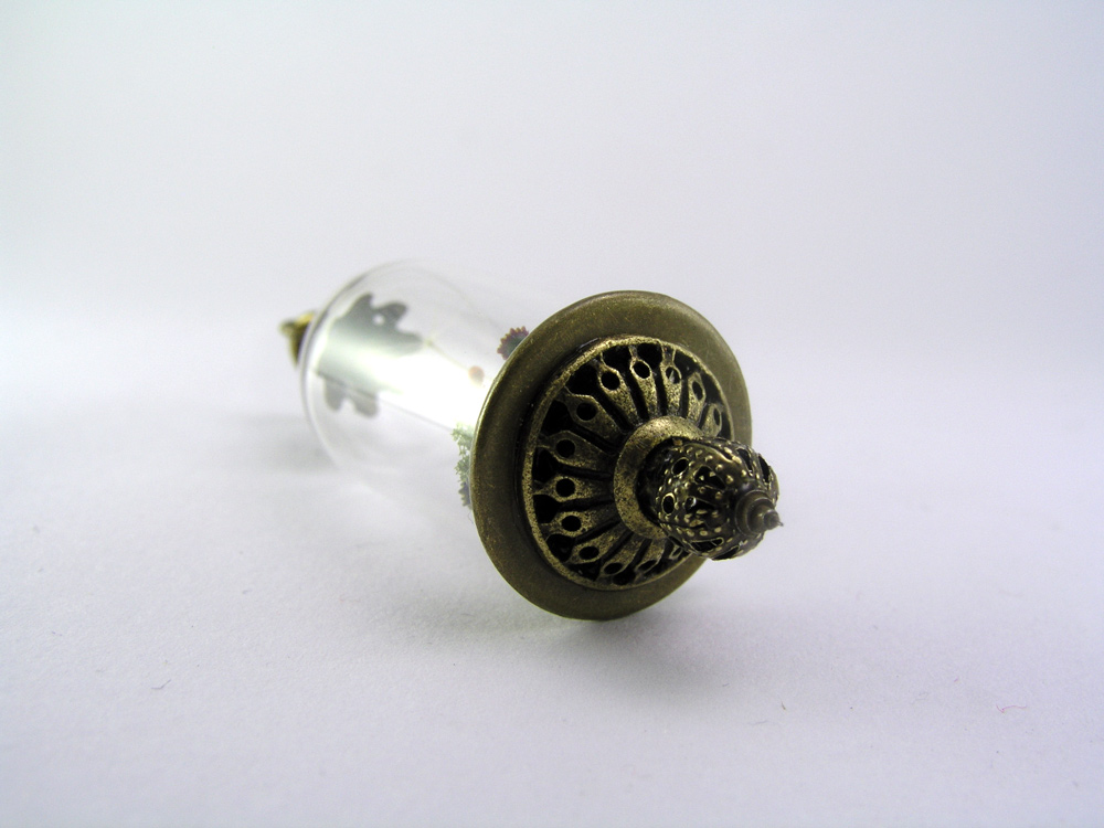 Miniature World pendant. A tiny girl is running among flower carrying a giant dandelion seed.