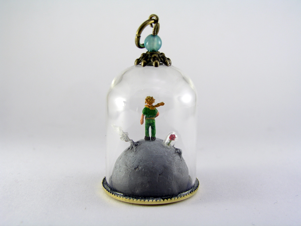 Miniature World - A little boy dressed in green is standing on a lonely planet
