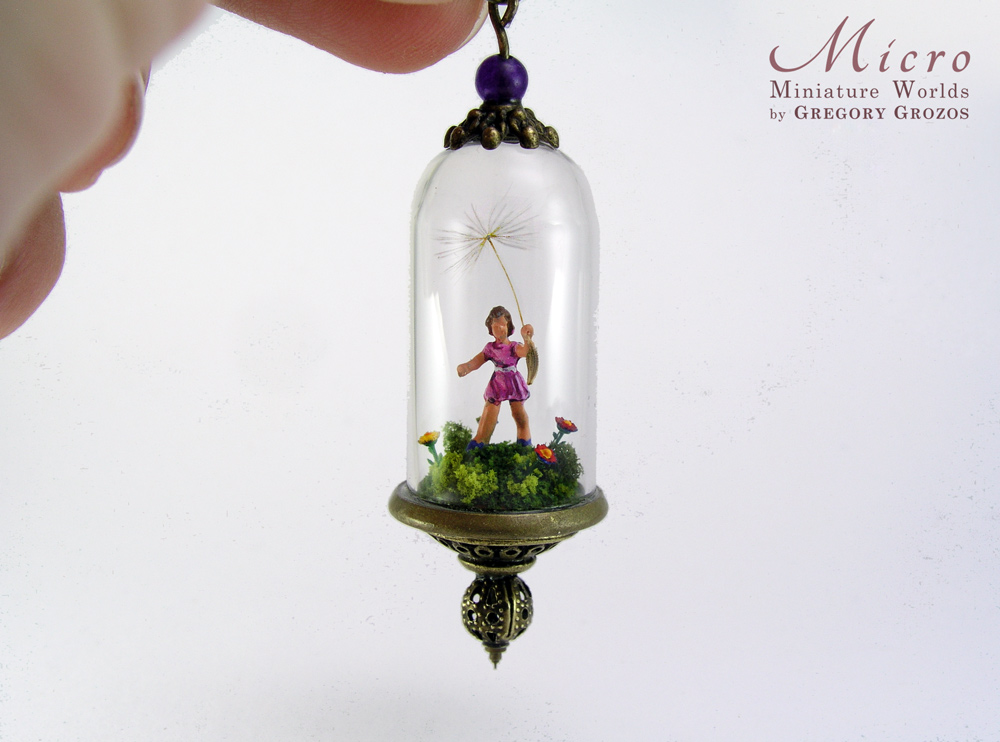 Miniature World pendant. A tiny girl is running among flower carrying a giant dandelion seed.