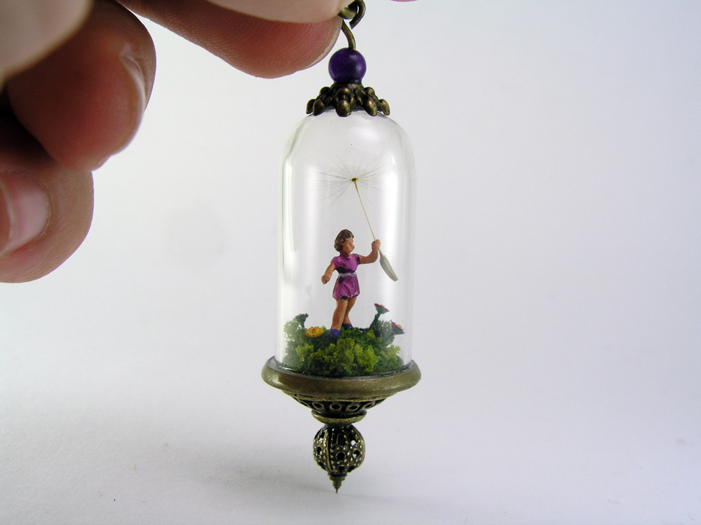Miniature World pendant. A tiny girl is running among flower carrying a giant dandelion seed.