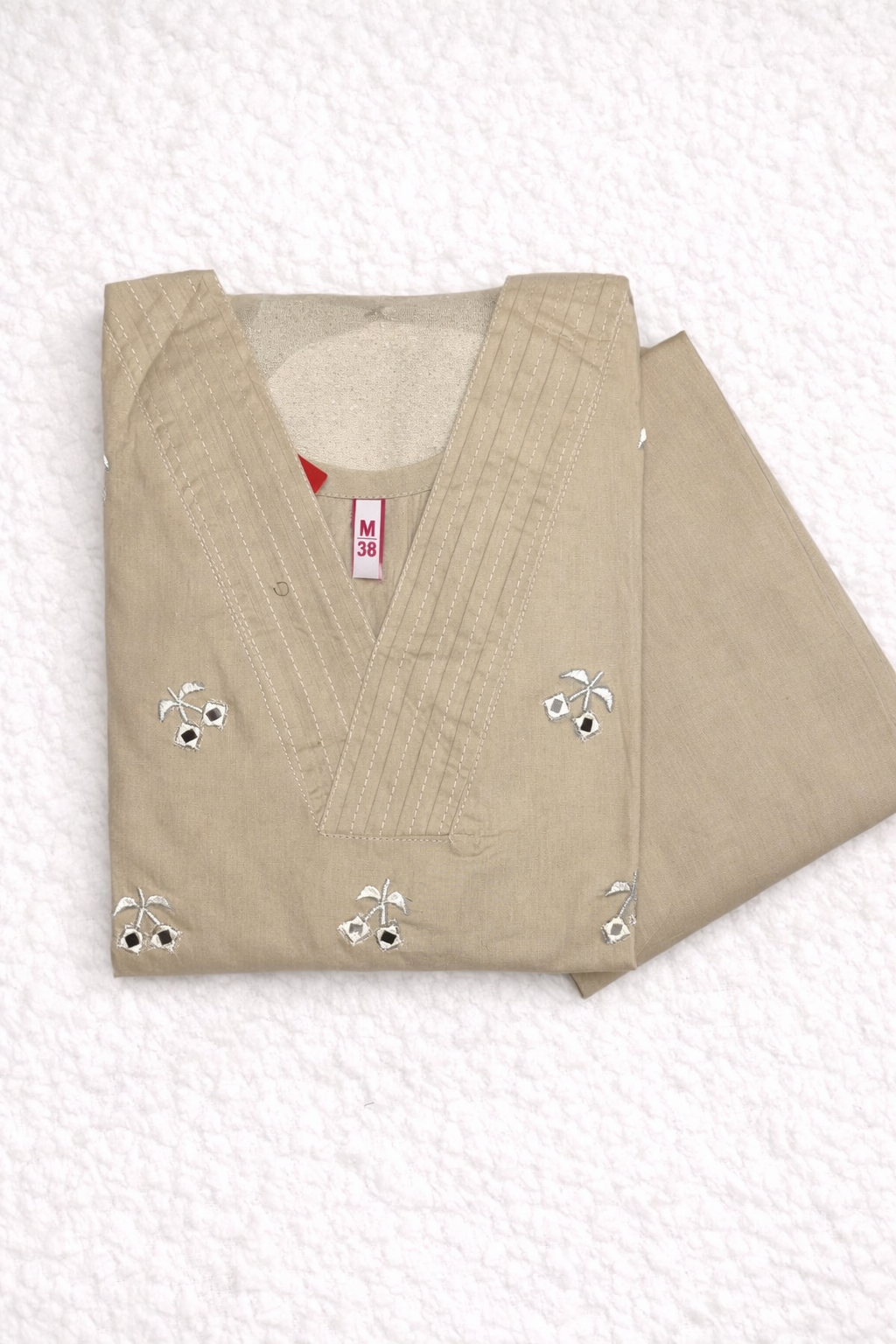 The Garment in the  image is a light grey colour .it is a natural, muted tone