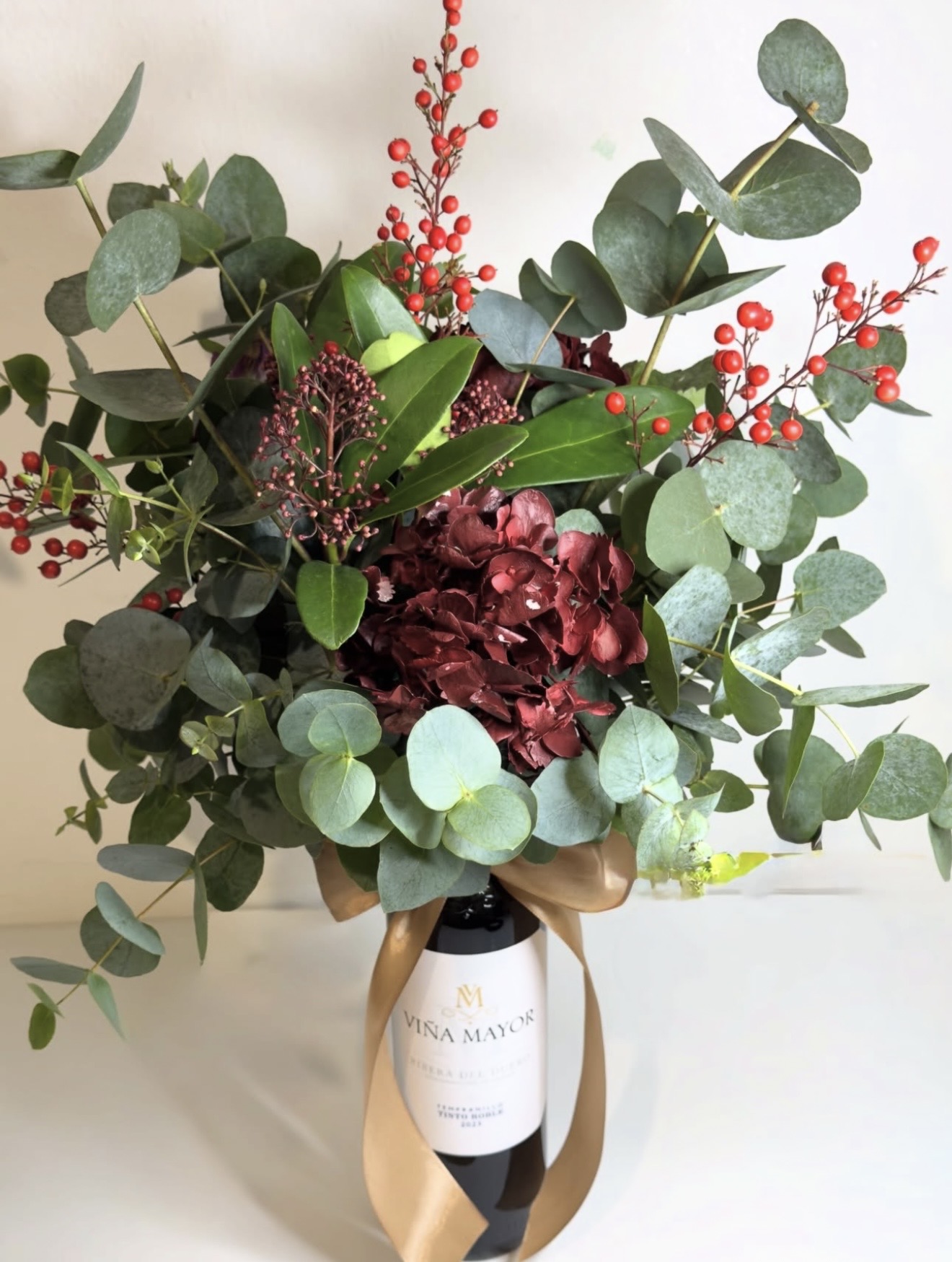 Ramo floral con botella de vino