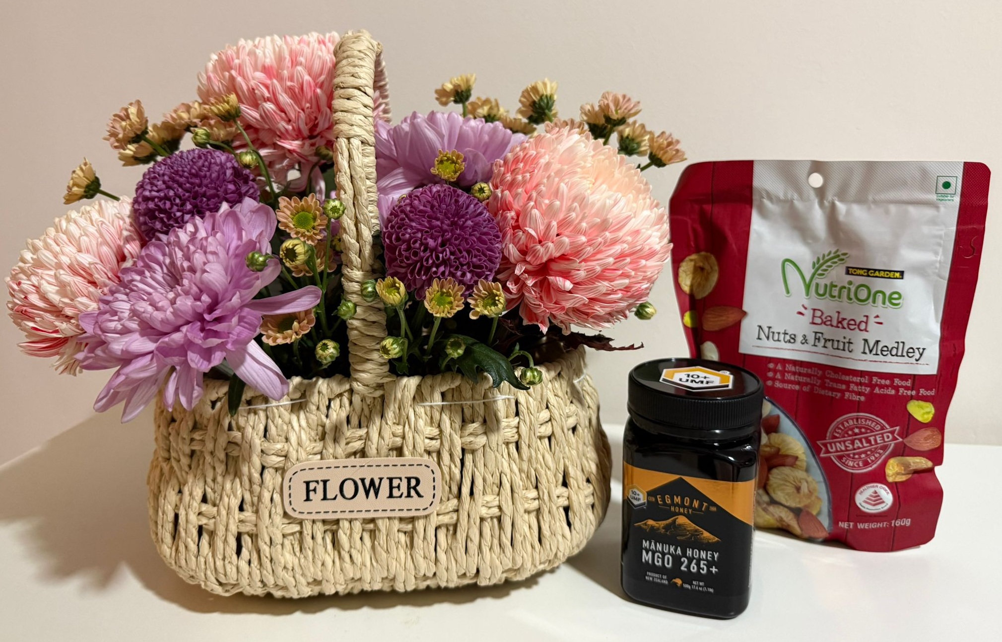 Pink and Purple Chrysanthemum Basket Arrangement with Manuka Honey and Baked Nuts