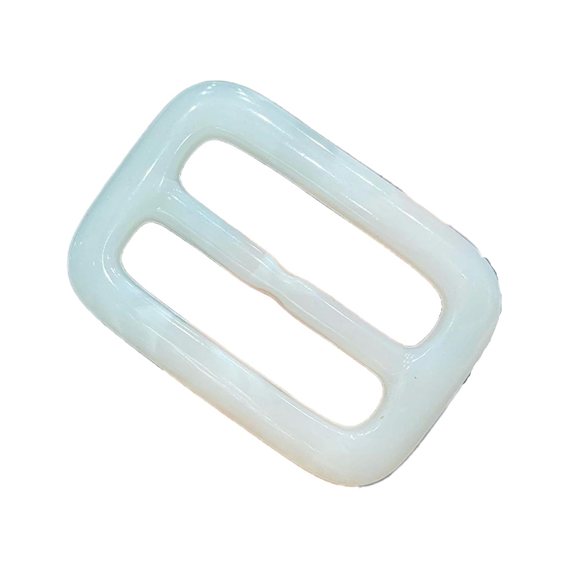 This white and black resin buckle is commonly used as an adjuster for backpack straps or belts.