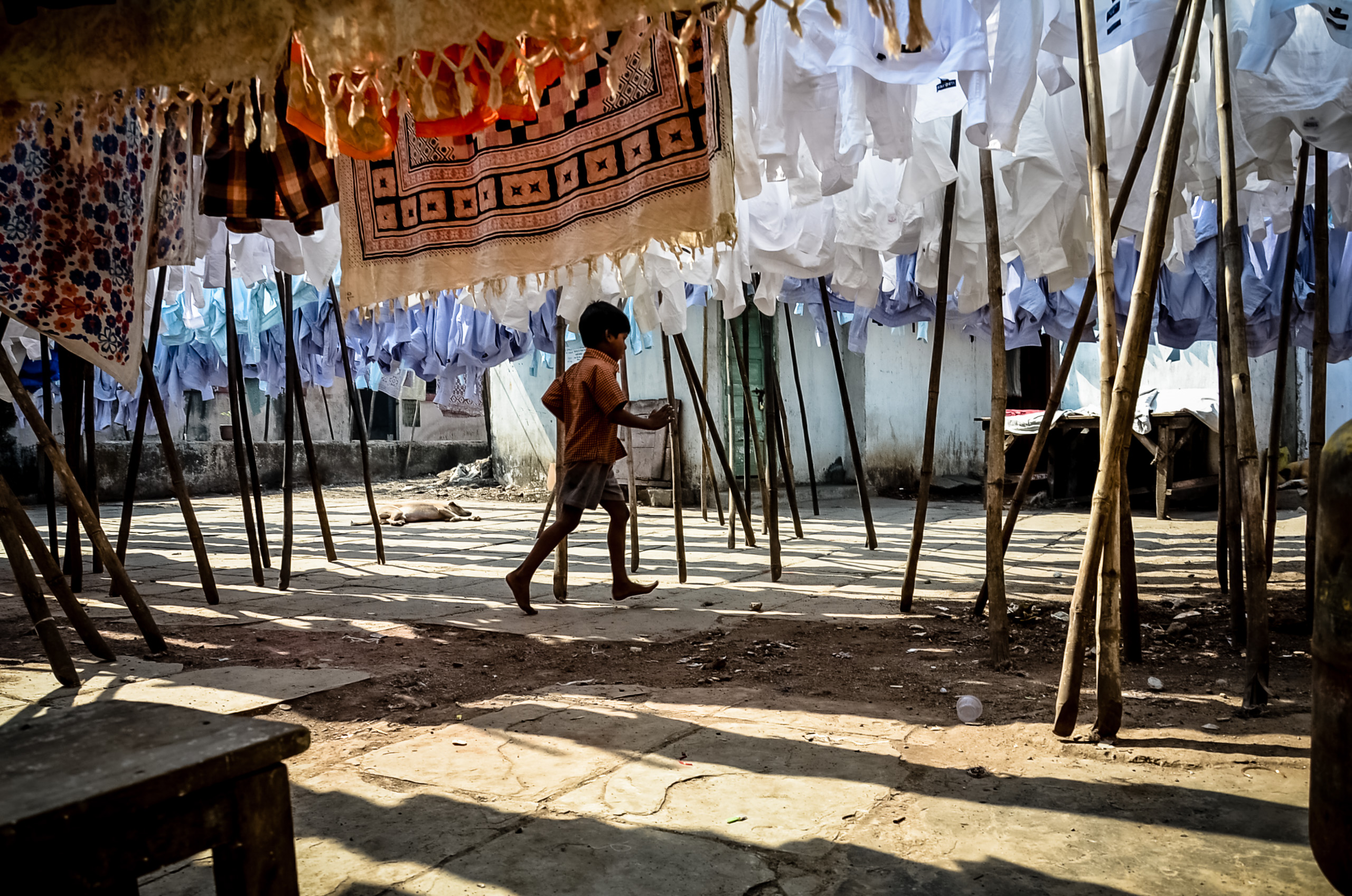 Boy Running Under Drying Laundry Photo Print