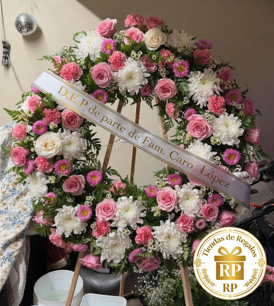 Corona fúnebre de flores rosadas y blancas