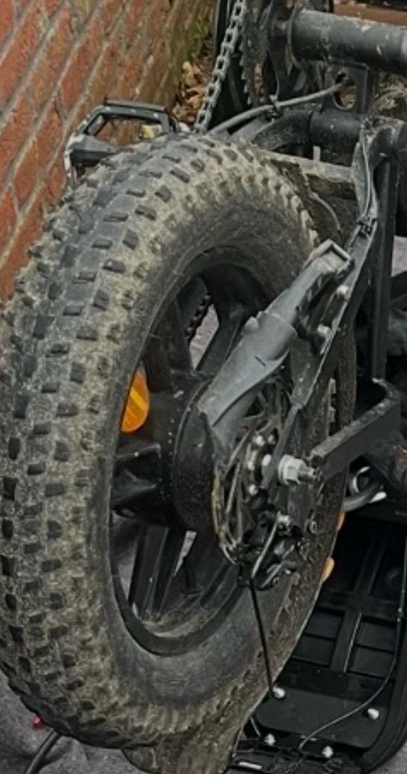 Mini fat bike repairing a flat rear wheel and mounting new tires on the rear wheel