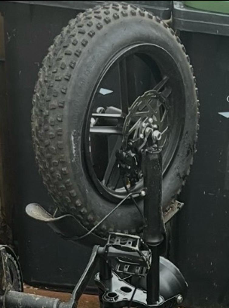 Mini fat bike repairing a flat front tire and mounting new tires on the front wheel